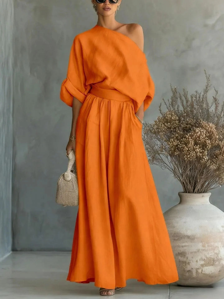 Orange off-shoulder crop top and wide-leg trouser set on standing model