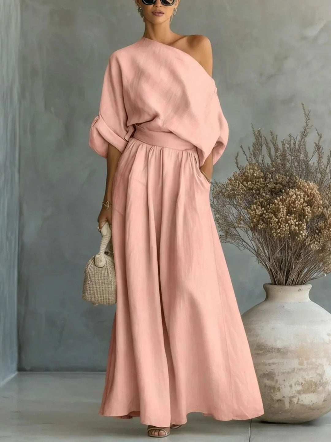 Pink off-shoulder crop top and wide-leg trouser set on standing model