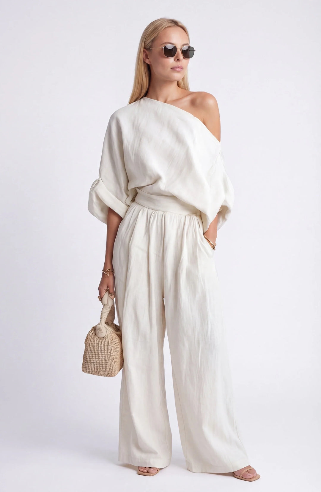 White off-shoulder crop top and wide-leg trouser set, model at three-quarter turn