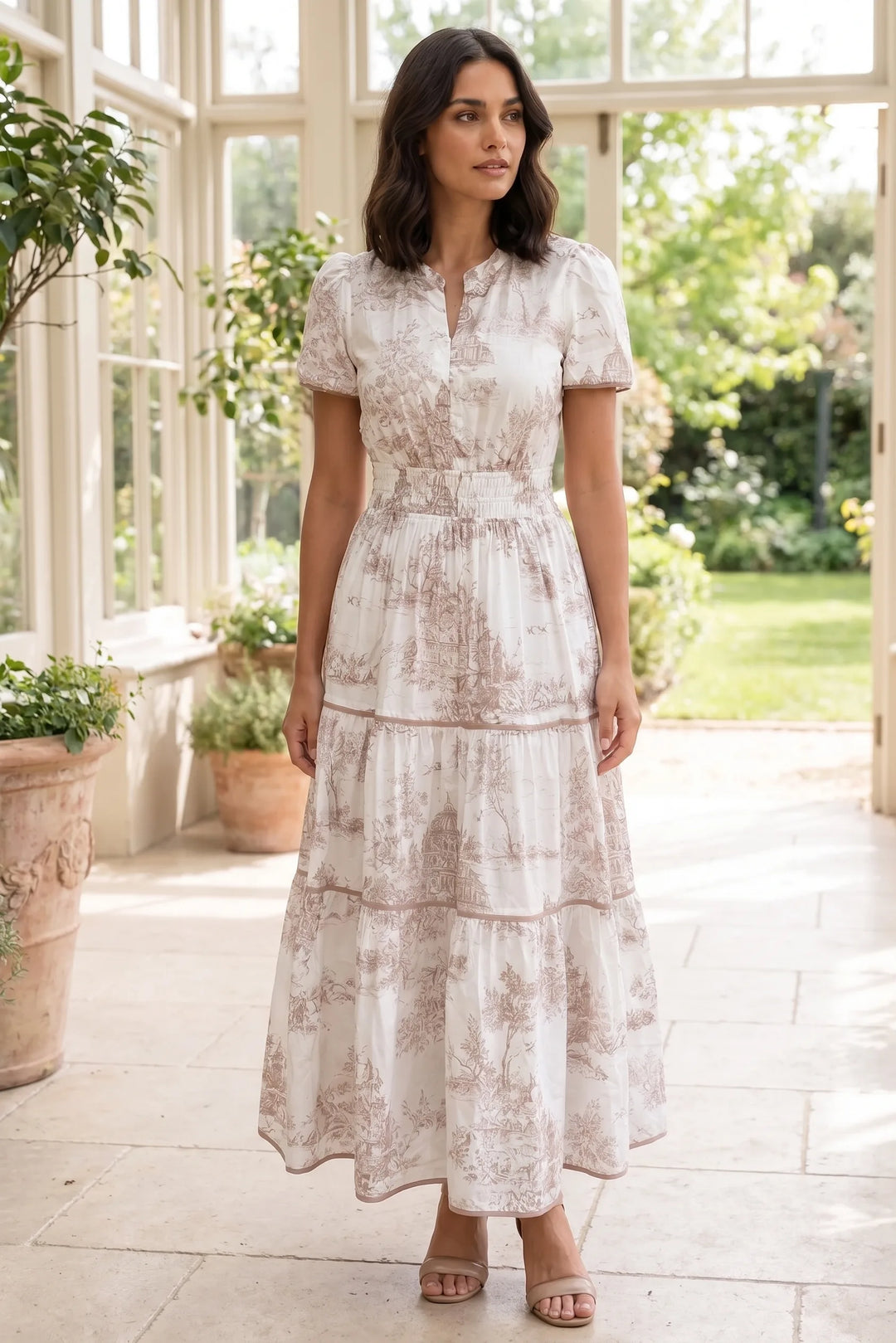 Model wearing a brown tiered toile maxi dress in a lifestyle setting