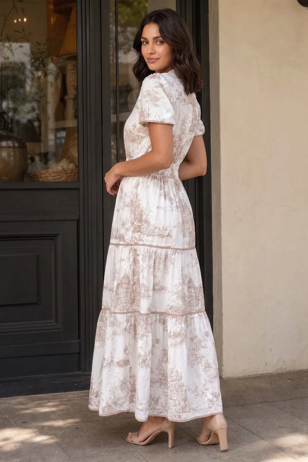 Brown tiered toile maxi dress on a model in a three-quarter turn