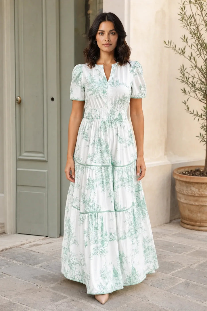 Green tiered toile maxi dress on a model in a contrapposto stance