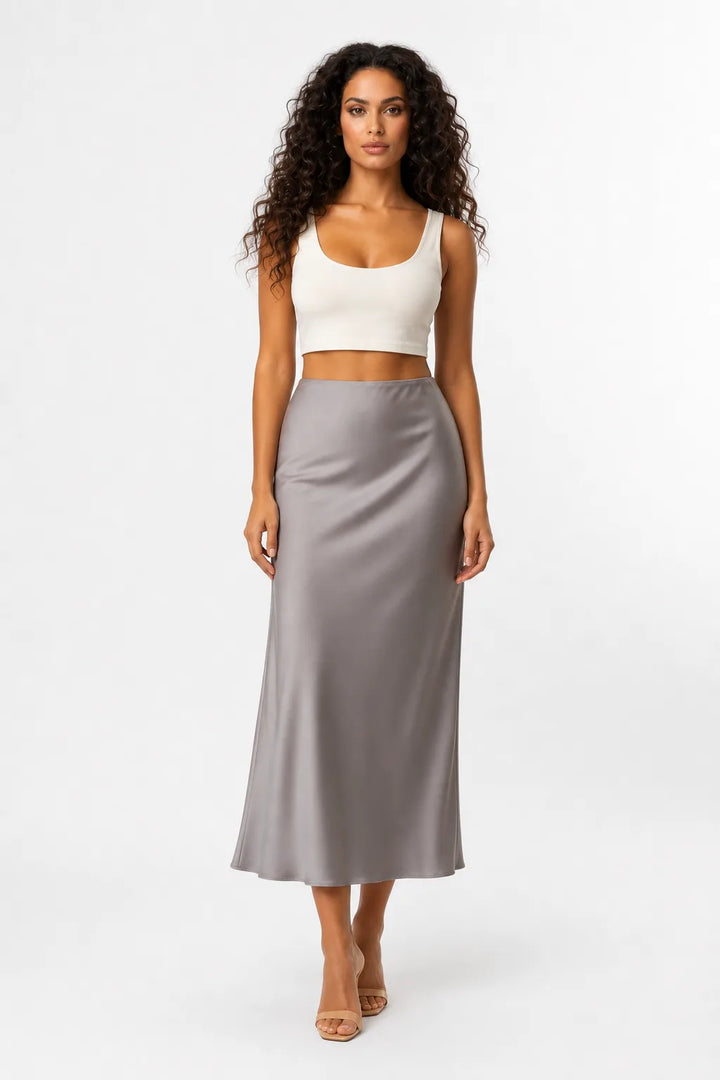Light brown satin midi skirt on model in contrapposto stance