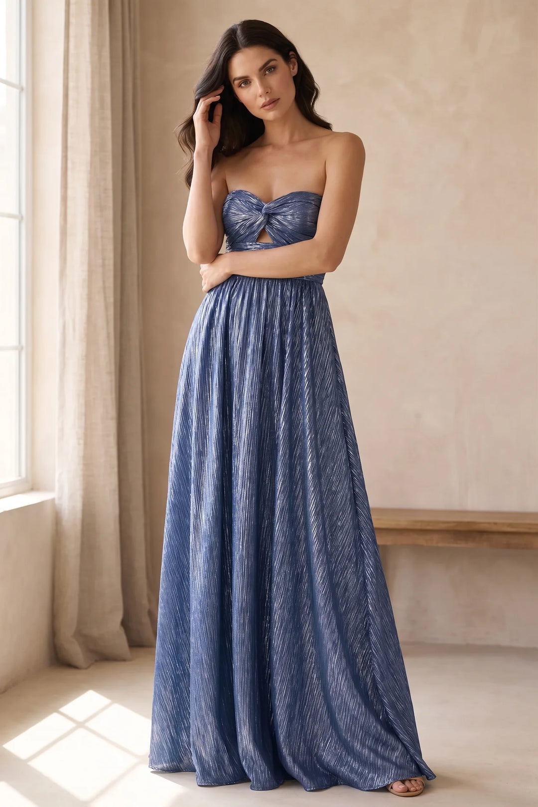 Model wearing blue twist front floor-length gown in lifestyle setting
