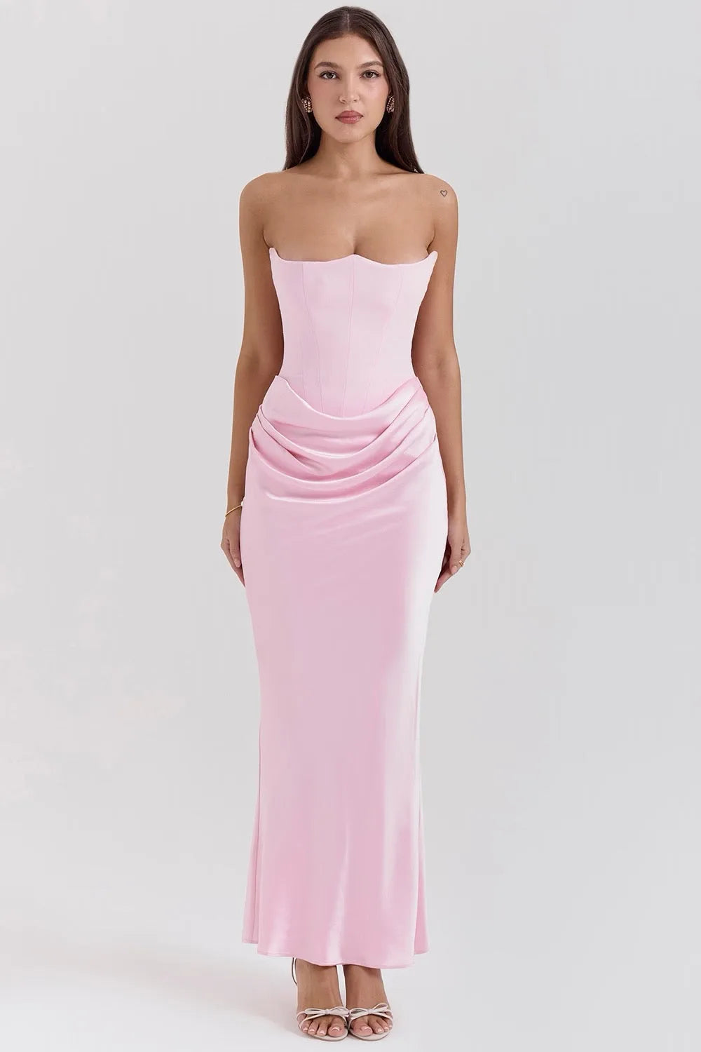 Pink corset maxi gown on model in side pose