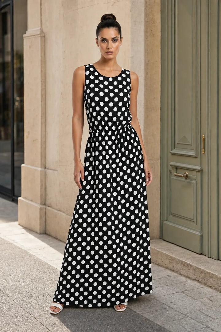 Black polka dot maxi dress on model in contrapposto stance