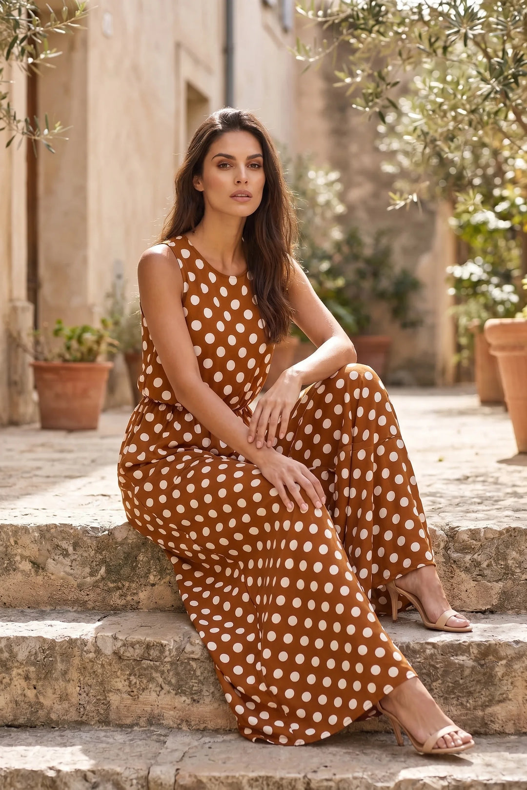 Model wearing brown polka dot maxi dress in outdoor lifestyle setting