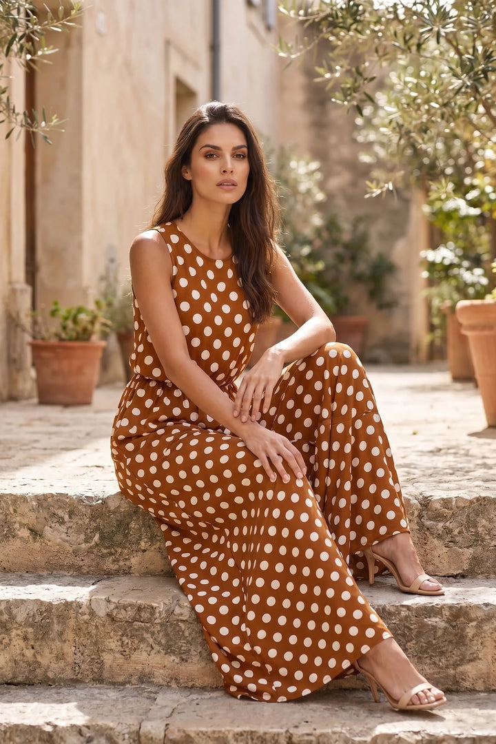 Model wearing brown polka dot maxi dress in outdoor lifestyle setting