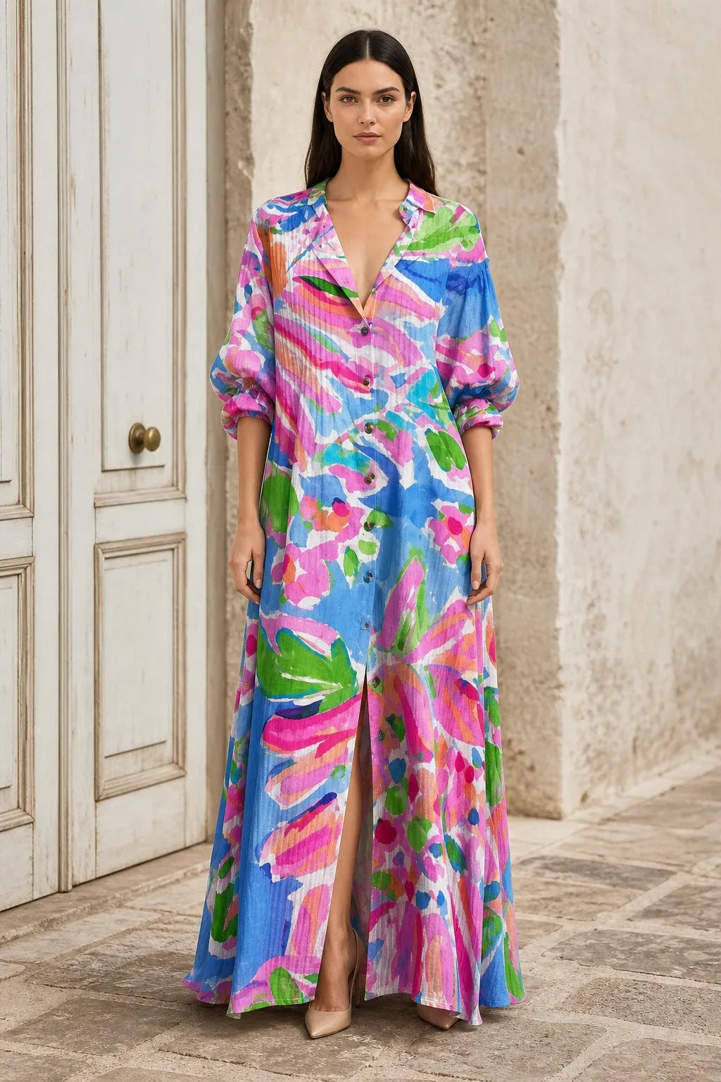Pink floral tiered maxi dress on model in contrapposto stance