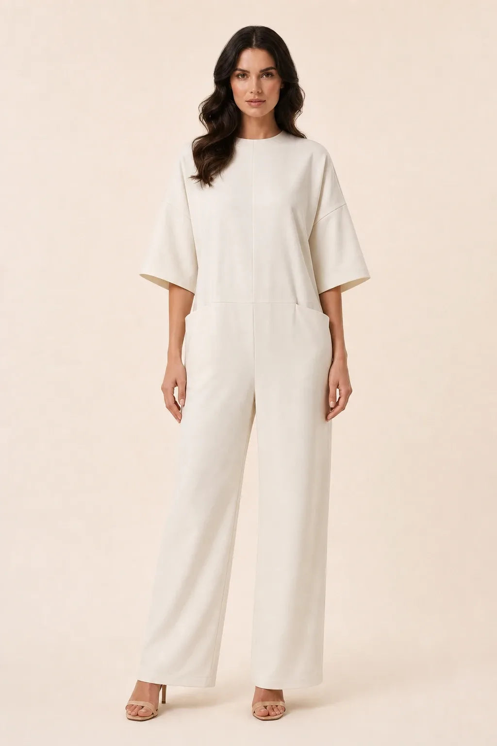 White wide-leg jumpsuit on model in contrapposto stance, front view