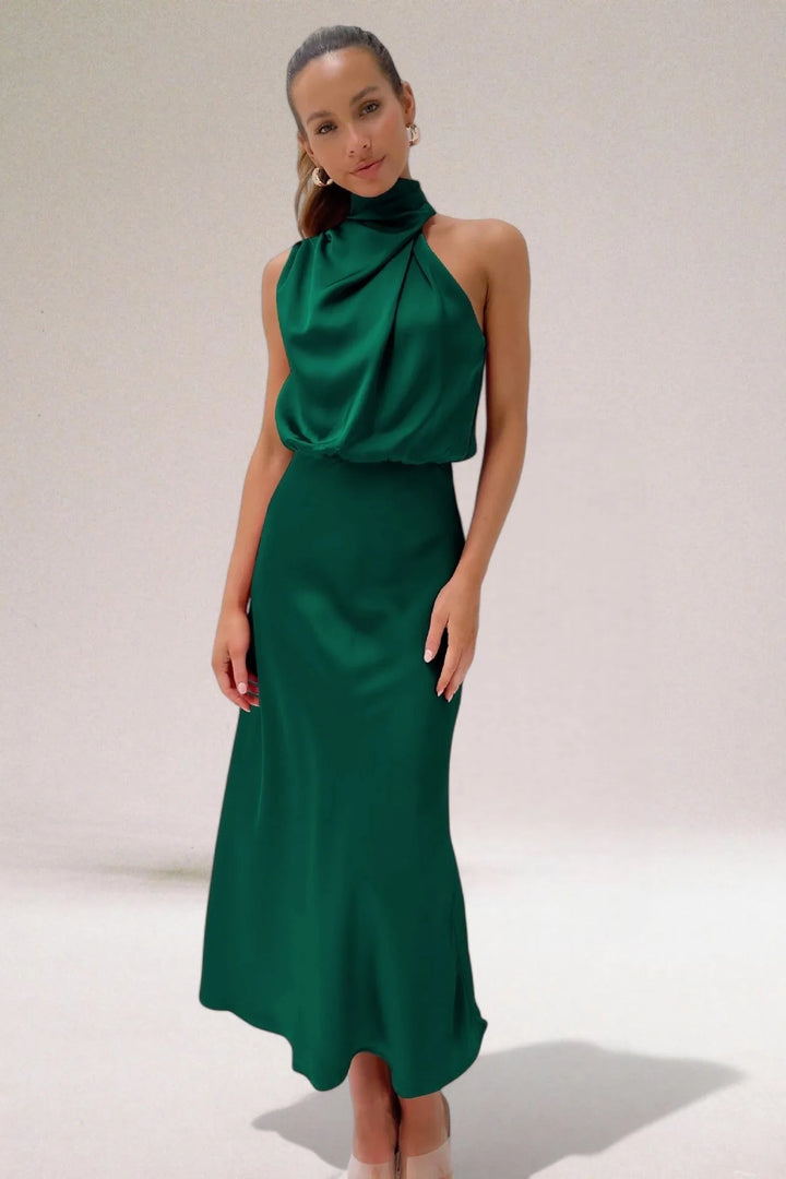 Model wearing a green draped halter midi dress