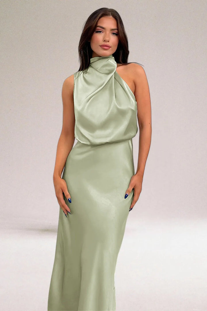 Model facing forward in a light green draped halter midi dress