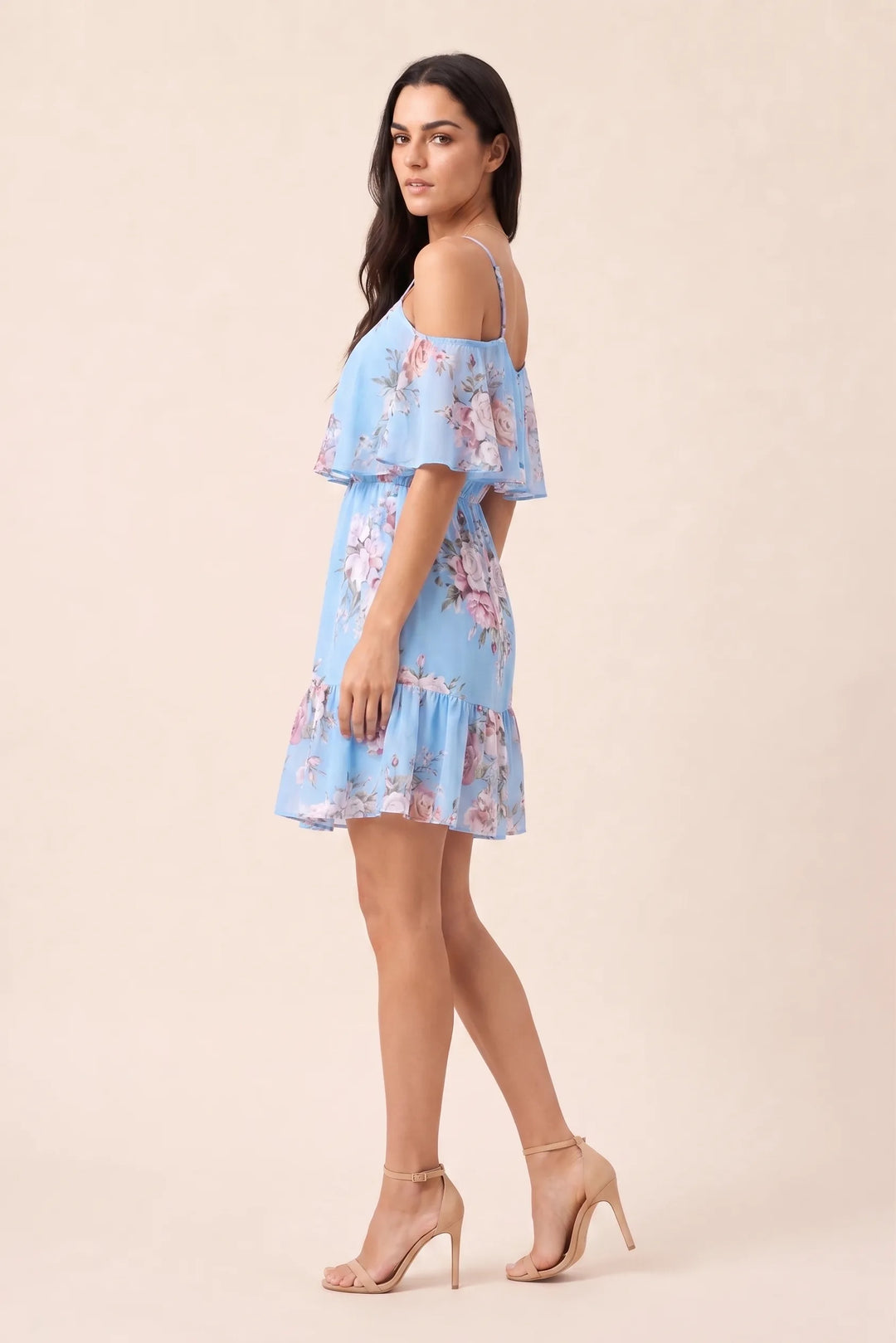 Light blue cold shoulder ruffle mini dress on model in three-quarter turn