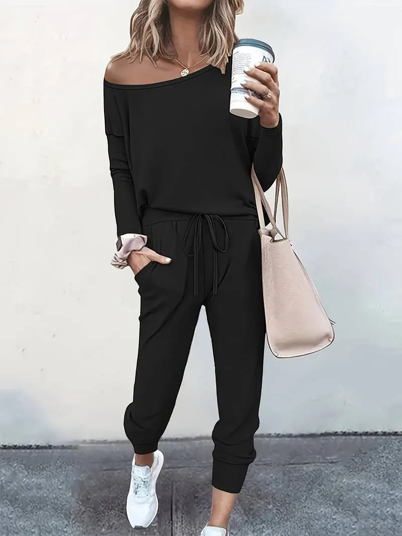 Black off-shoulder sweatshirt and jogger set on a model shown from the side