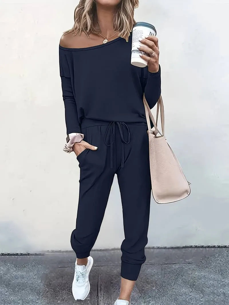 Close-up detail of a blue off-shoulder sweatshirt and jogger set on a model