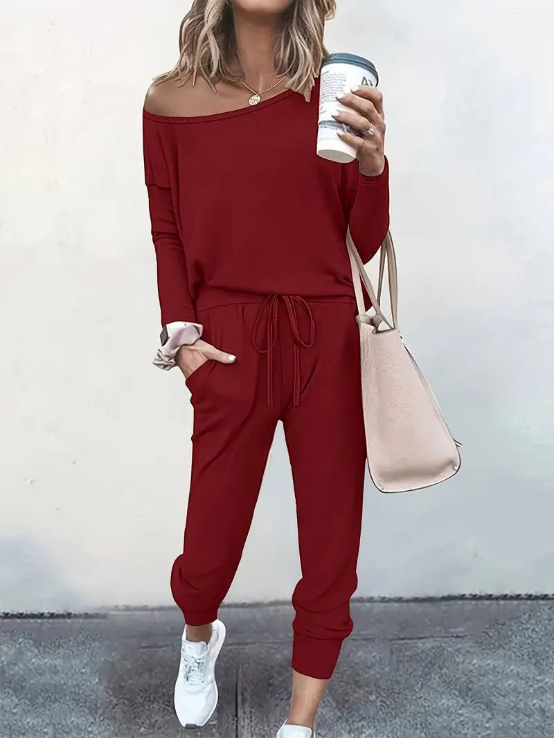 Red off-shoulder sweatshirt and jogger set styled on a model