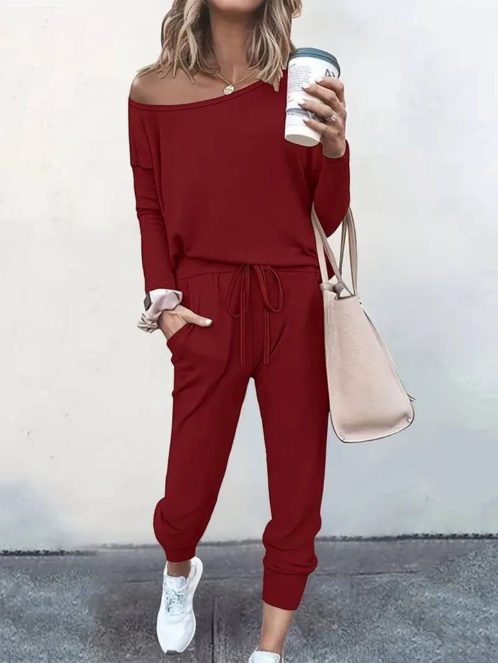 Red off-shoulder sweatshirt and jogger set styled on a model
