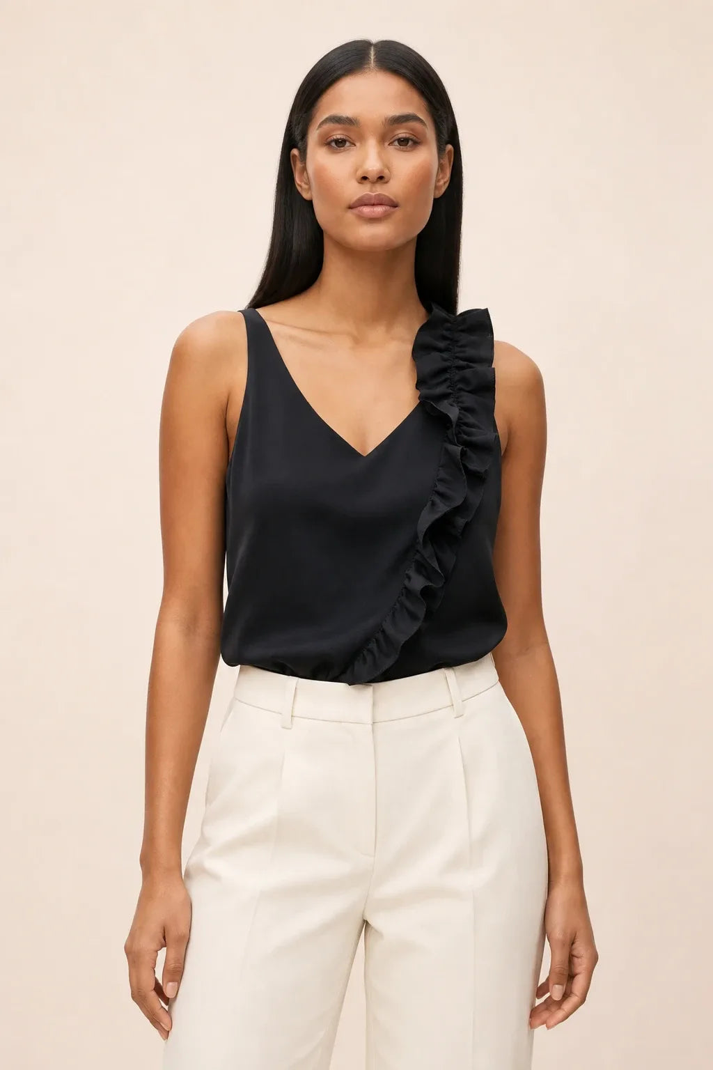 Black asymmetric ruffle cami on model in contrapposto stance