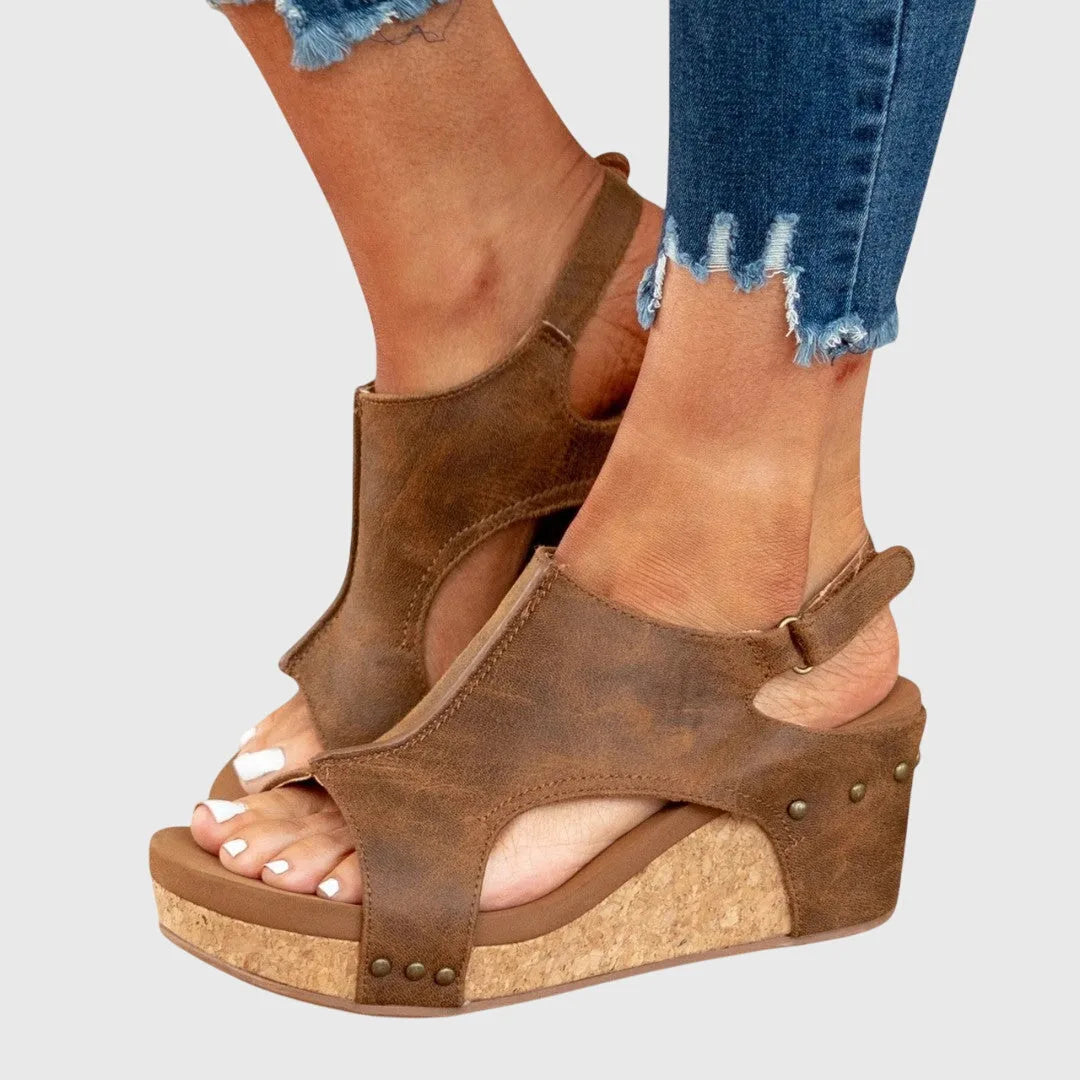 Beige wedge platform sandal close-up view of strap and buckle detailing