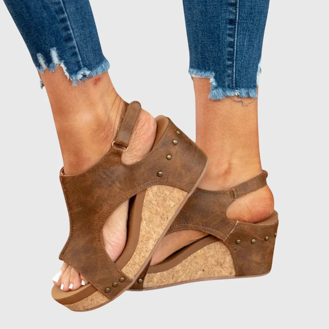 Beige wedge platform sandal styled angle emphasizing platform and heel height
