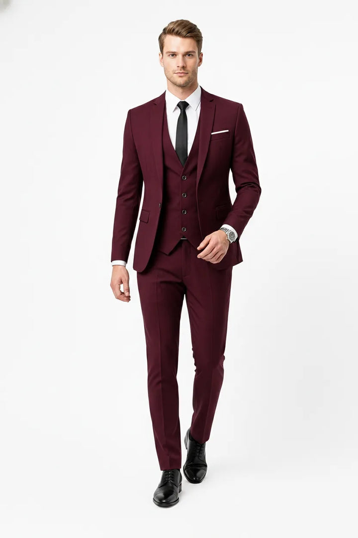 Slim burgundy three-piece suit on male model in natural movement