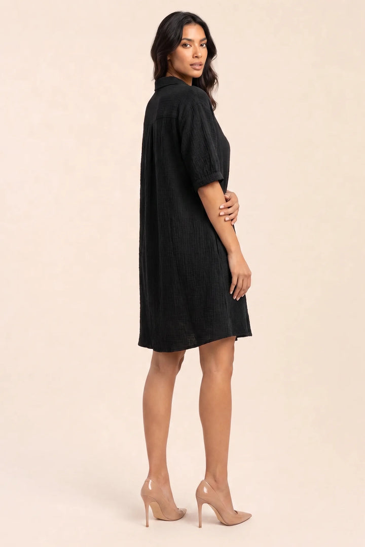Black gauze shirt dress on model in three-quarter turn, showing drape and back detail