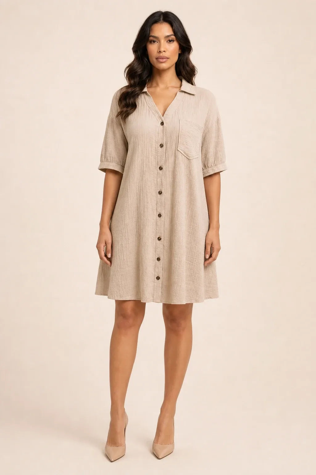 Khaki gauze shirt dress on model in contrapposto stance, relaxed collar and button-front silhouette