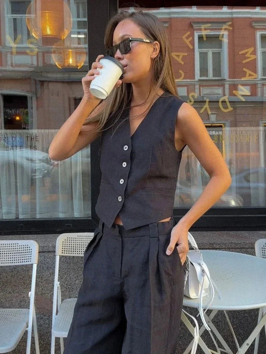 Beige sleeveless vest and wide-leg trouser co-ord set, model in side profile