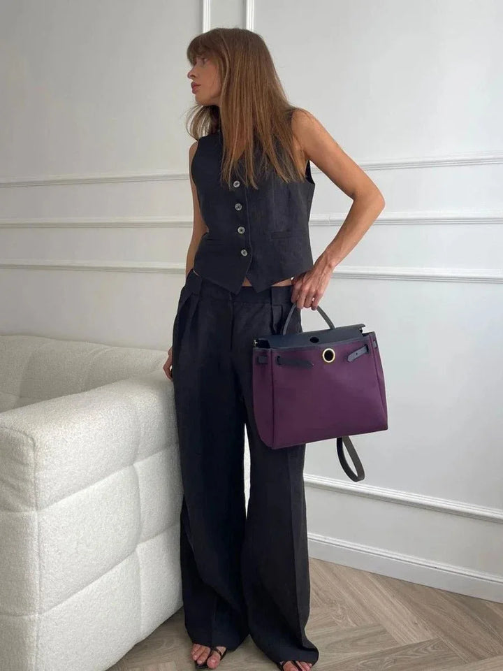 Black sleeveless vest and wide-leg trouser co-ord set, model at three-quarter turn