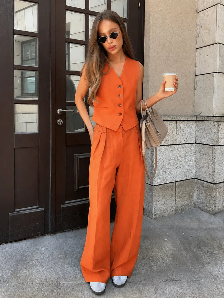 Close-up detail of orange sleeveless vest and wide-leg trouser co-ord set