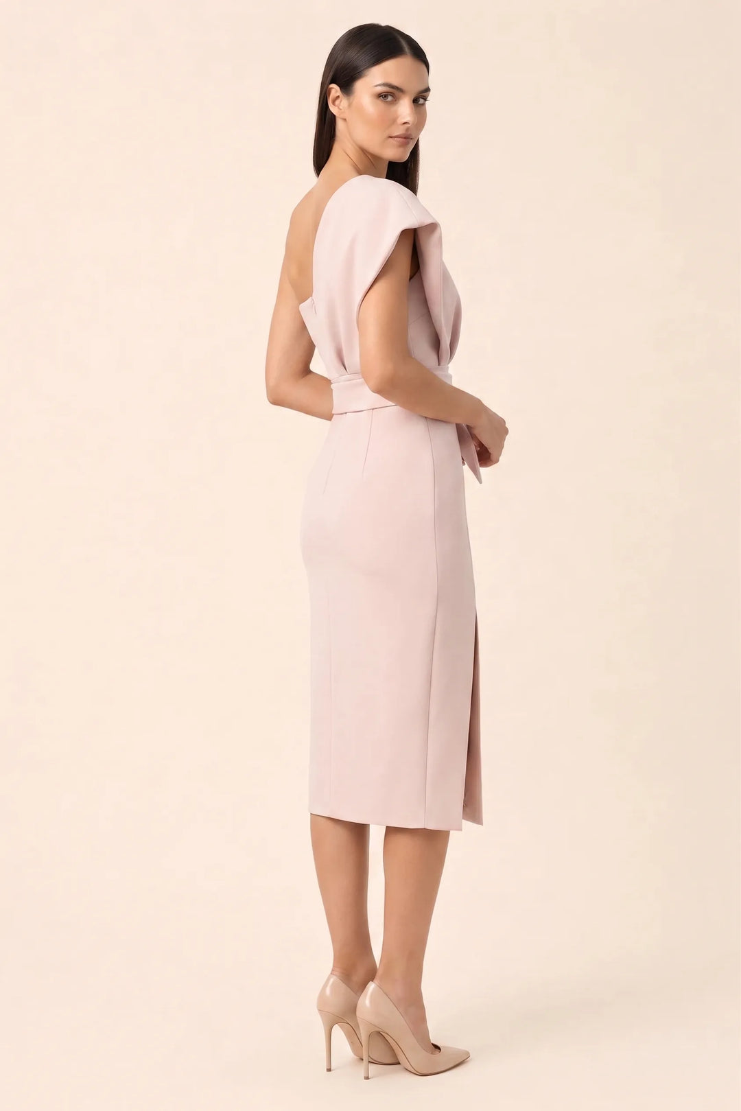 Pink one-shoulder belted midi dress on model in three-quarter turn