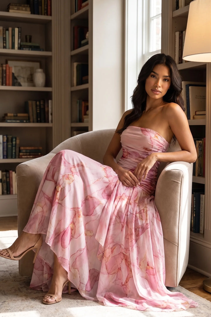 Woman in pink ruched high-low maxi dress in an outdoor lifestyle scene
