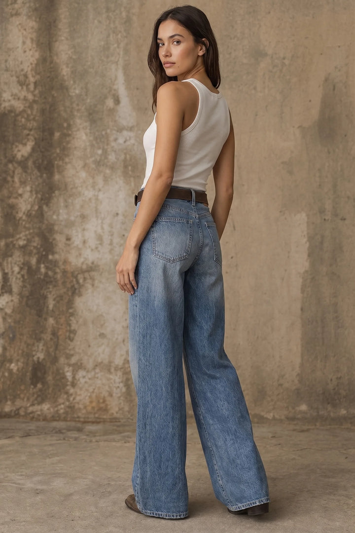 Light blue wide-leg flare jeans on a model in a three-quarter turn pose