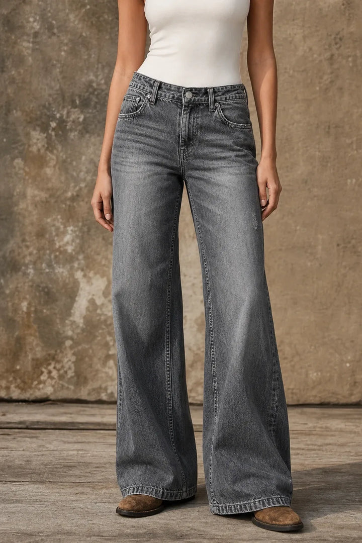 Light gray wide-leg flare jeans on a model in a contrapposto stance