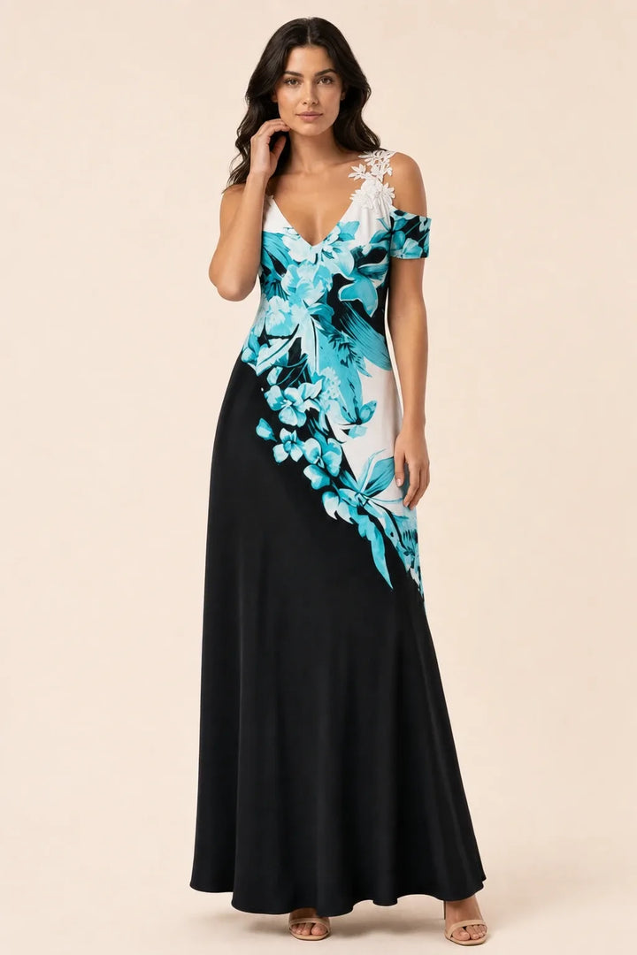 Black, white, and blue cold shoulder maxi dress on model in contrapposto stance