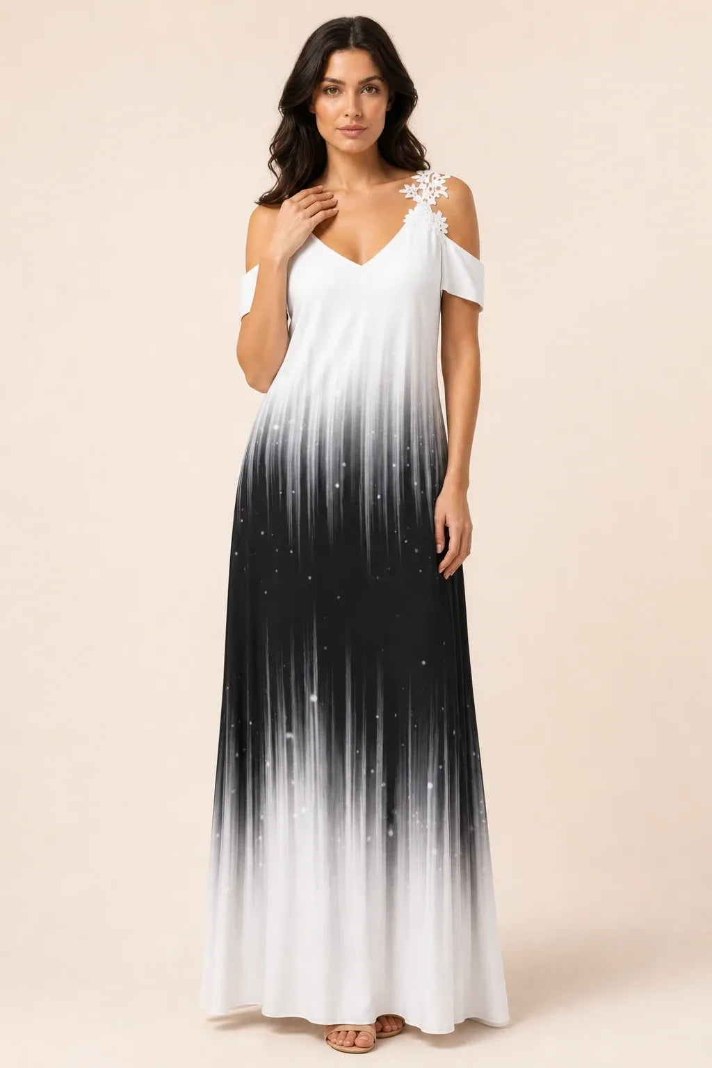 Black and white cold shoulder maxi dress on model in contrapposto stance