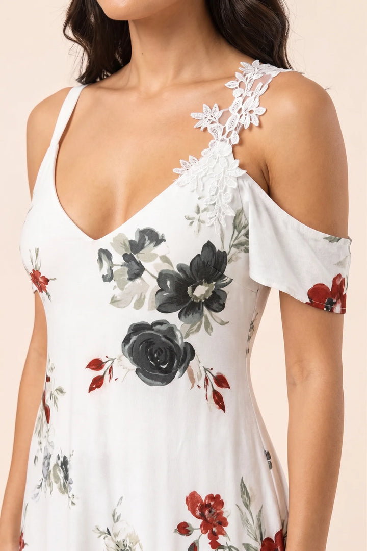 Close-up detail of white cold shoulder maxi dress neckline and sleeve cutout