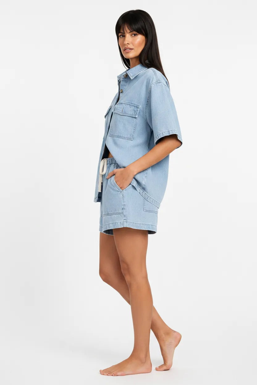 Light blue denim shirt set on model in three-quarter turn