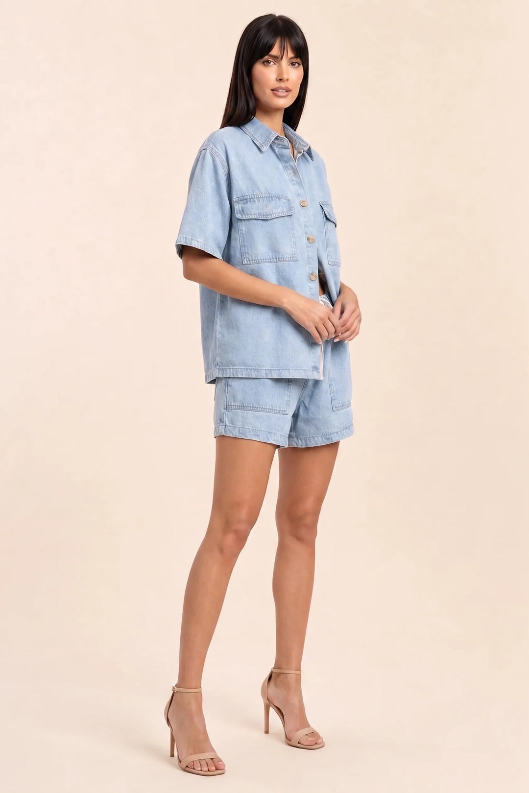 Light blue denim shirt set on model in three-quarter turn