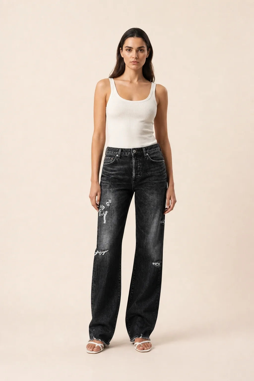 Black distressed wide leg jeans on a model in a contrapposto stance