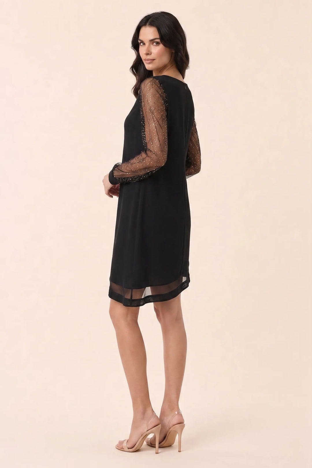 Silver glitter mesh mini dress on model in three-quarter turn
