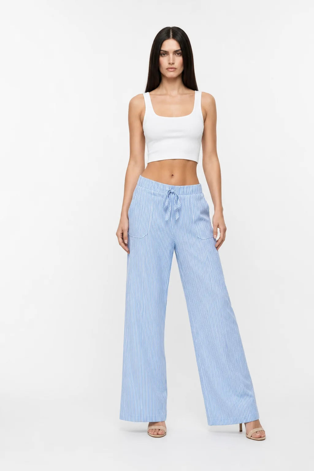 Blue striped wide-leg pants on a model in a contrapposto stance