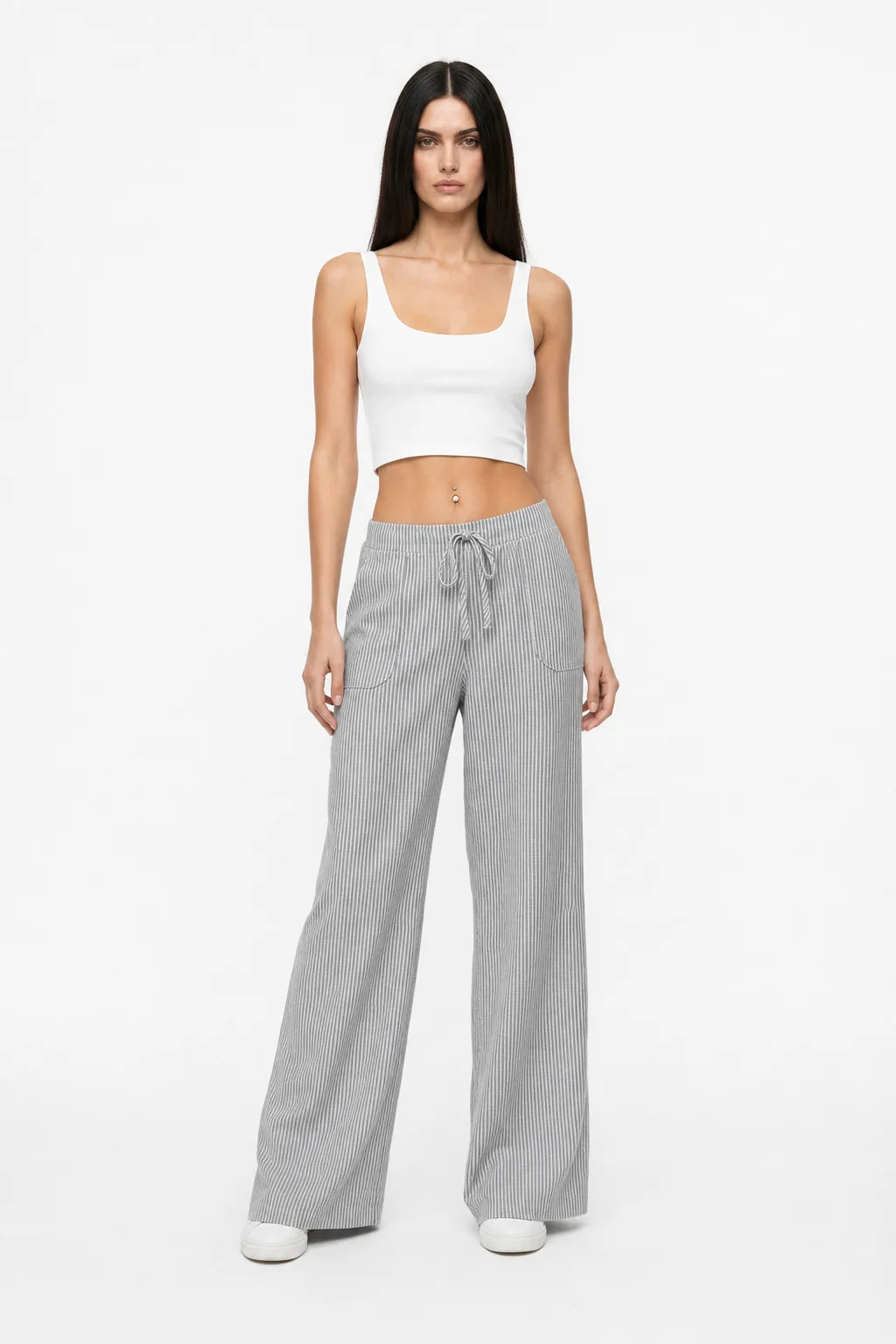 Grey striped wide-leg pants on a model in a contrapposto stance