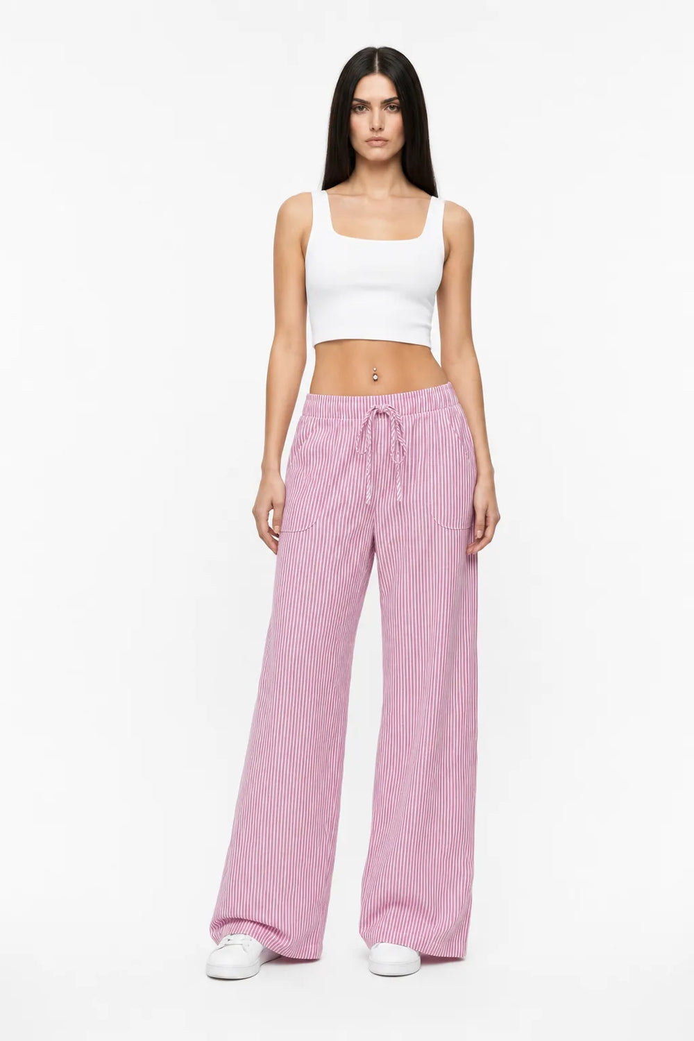 Pink striped wide-leg pants on a model in a contrapposto stance