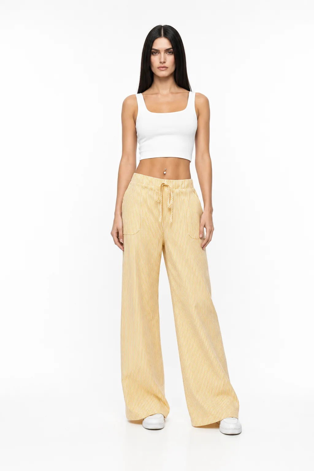 Yellow striped wide-leg pants on a model in a contrapposto stance