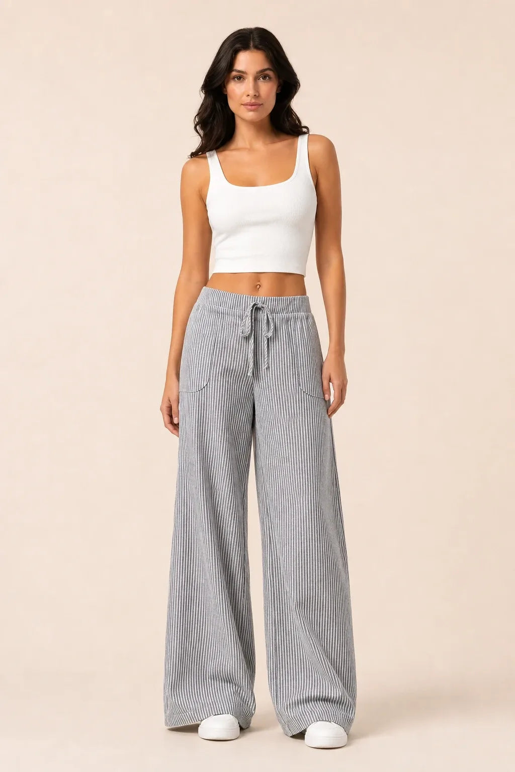 Grey striped wide-leg pants on model in contrapposto stance