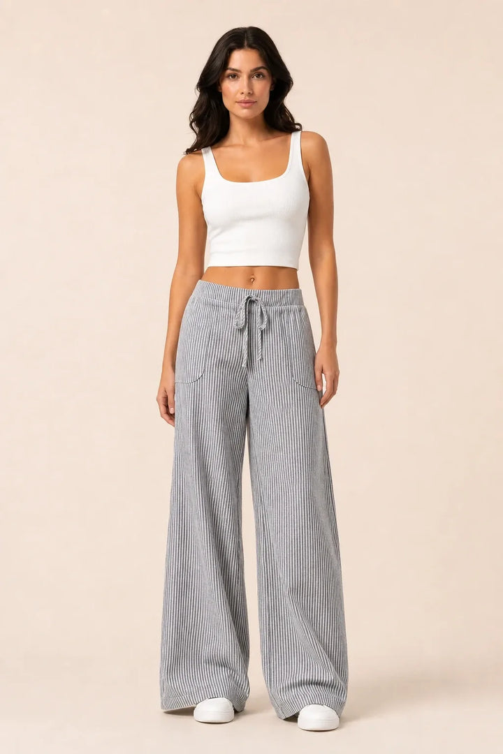 Grey striped wide-leg pants on model in contrapposto stance