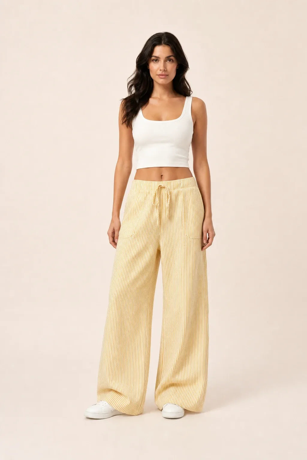Yellow striped wide-leg pants on model in contrapposto stance