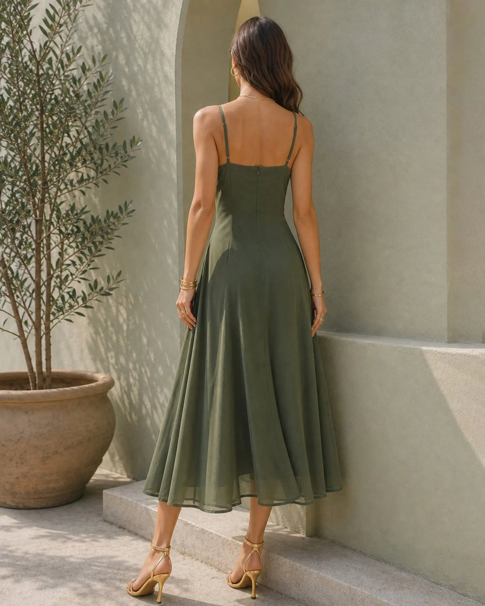 Close-up detail of the cowl neckline on a green midi dress