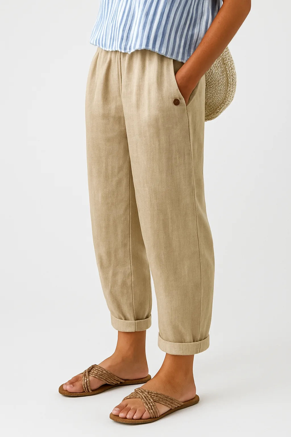 Beige tapered pants with rolled cuffs, model facing forward